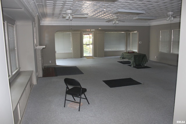 interior space featuring carpet, ceiling fan, and a fireplace