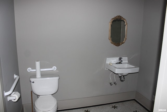 bathroom with tile patterned floors, toilet, and sink