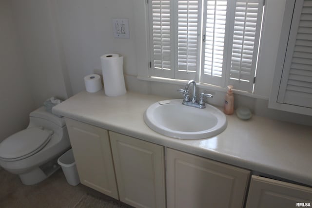 bathroom featuring vanity and toilet