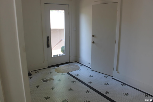 doorway featuring tile patterned floors and a wealth of natural light