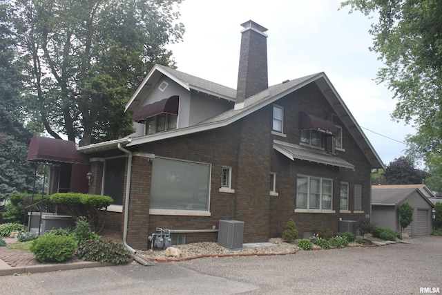 view of side of home featuring central AC