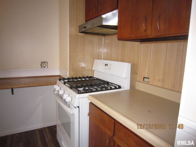 kitchen with dark hardwood / wood-style flooring and white range with gas cooktop