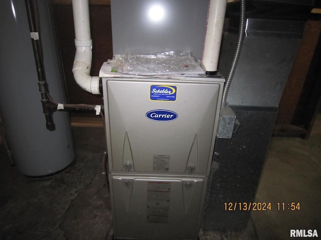 utility room featuring water heater