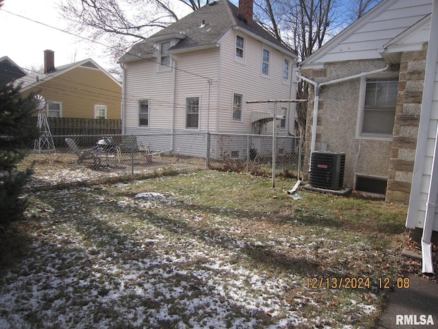 back of property featuring a chimney, central AC unit, fence, and roof with shingles