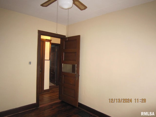 empty room featuring ceiling fan and dark hardwood / wood-style flooring