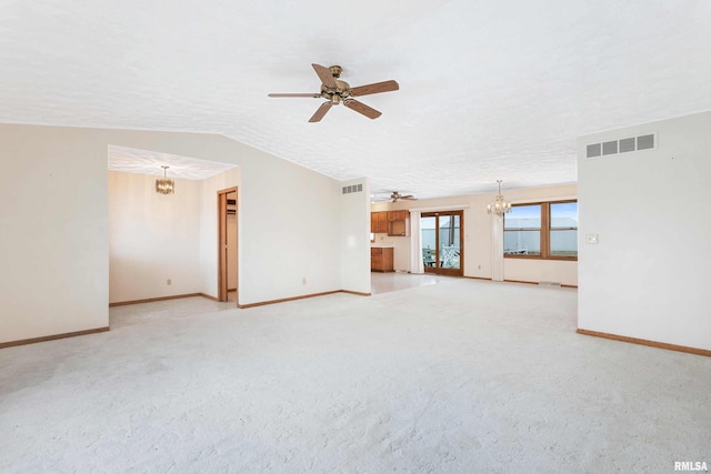 unfurnished living room with ceiling fan with notable chandelier, a textured ceiling, light carpet, and vaulted ceiling