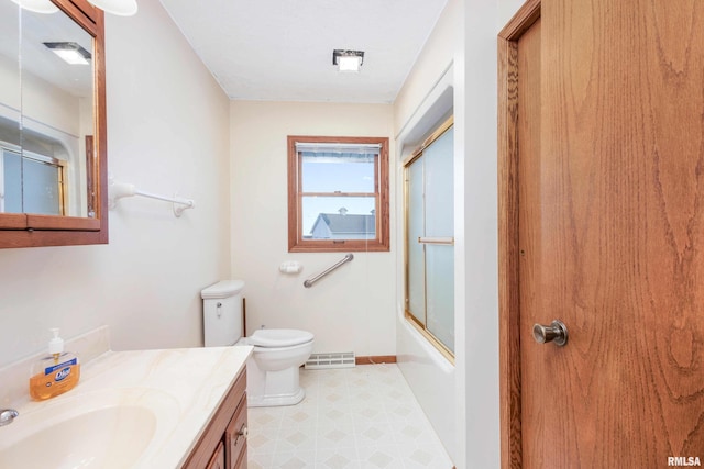 full bathroom featuring vanity, bath / shower combo with glass door, and toilet