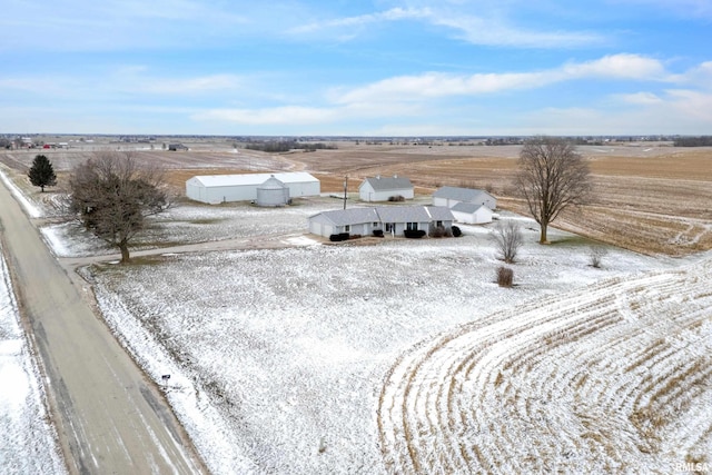 snowy aerial view featuring a rural view