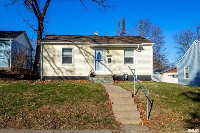 bungalow-style home featuring a front yard