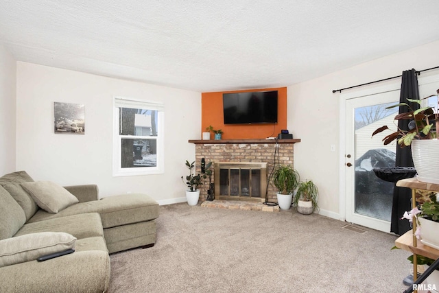 carpeted living room with a textured ceiling, a brick fireplace, and a wealth of natural light