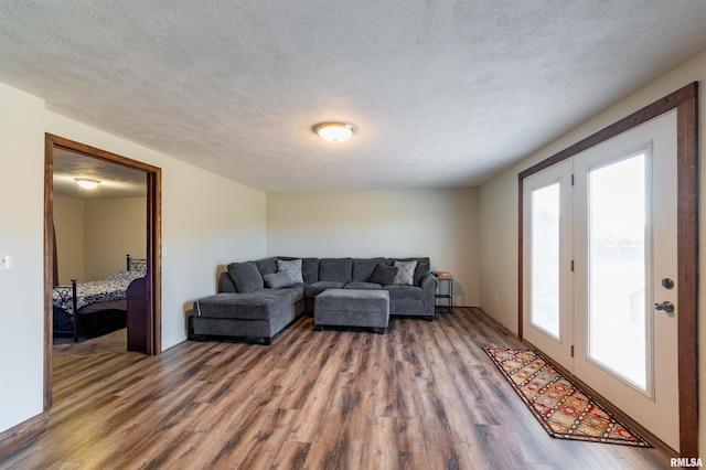 living room with a textured ceiling and hardwood / wood-style flooring