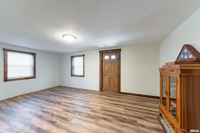 entryway with a textured ceiling and hardwood / wood-style flooring