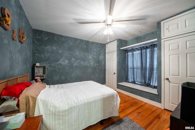 bedroom featuring hardwood / wood-style flooring and ceiling fan