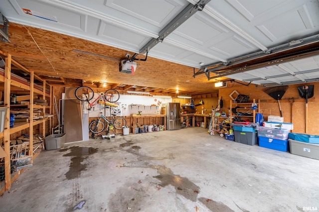 garage with a workshop area and a garage door opener