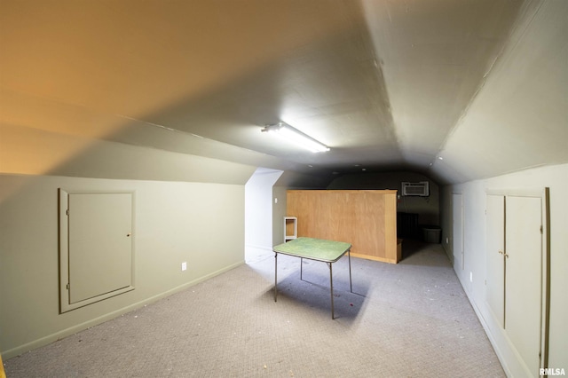 bonus room featuring light carpet, a wall mounted air conditioner, and vaulted ceiling