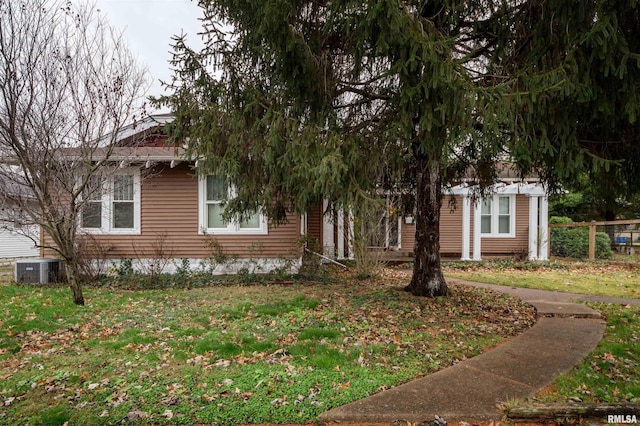 view of front of house featuring central AC unit and a front yard