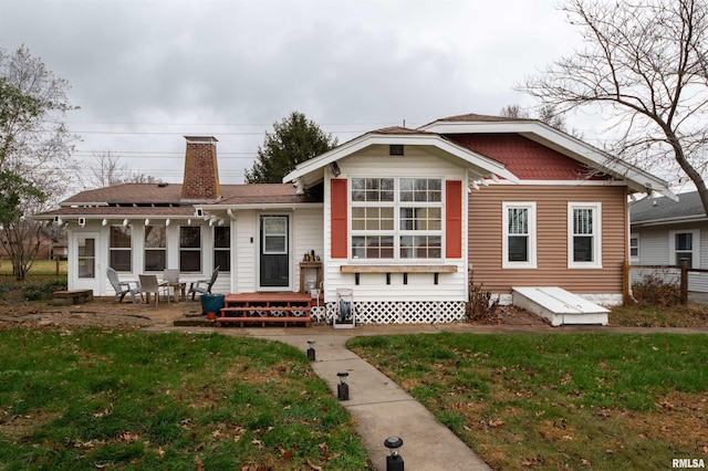 back of property featuring a lawn