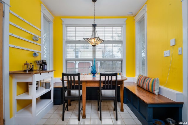 dining area featuring light tile patterned floors, breakfast area, and a notable chandelier