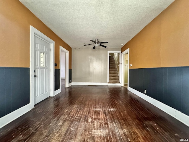 interior space featuring ceiling fan, hardwood / wood-style floors, and a textured ceiling