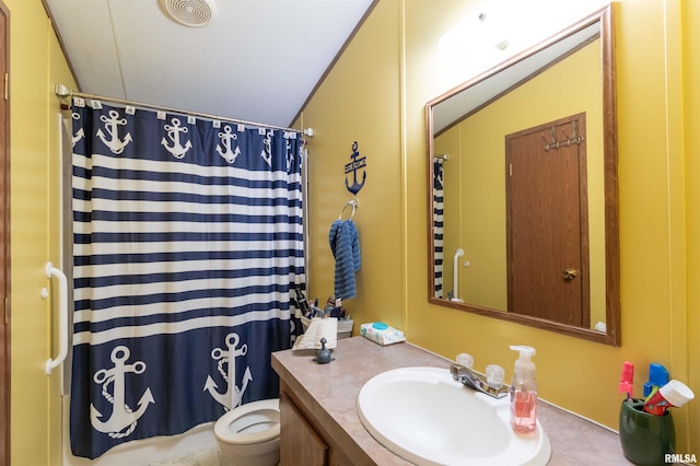 bathroom featuring vanity, toilet, and walk in shower