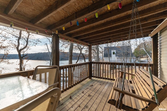 snow covered deck with a water view