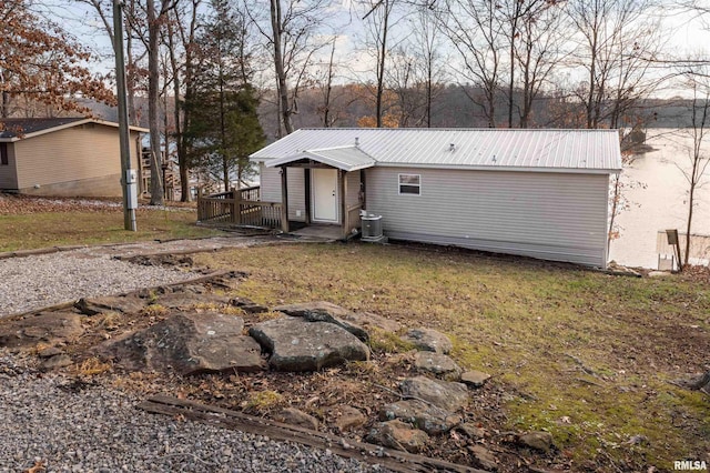 rear view of property featuring a wooden deck