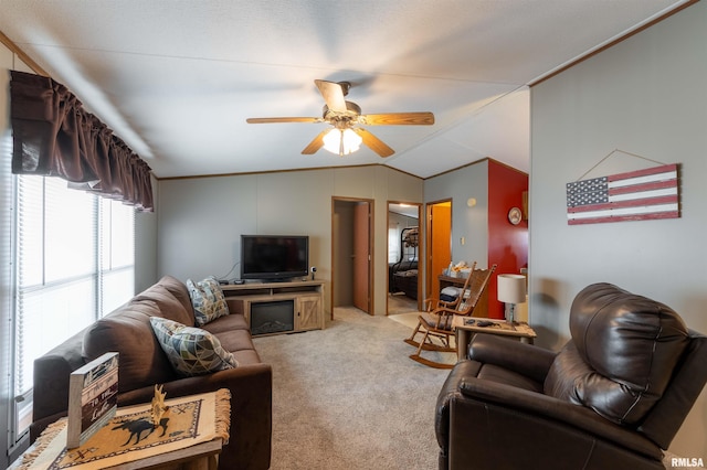 carpeted living room with ceiling fan and lofted ceiling