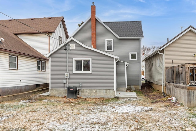 back of house featuring central AC unit