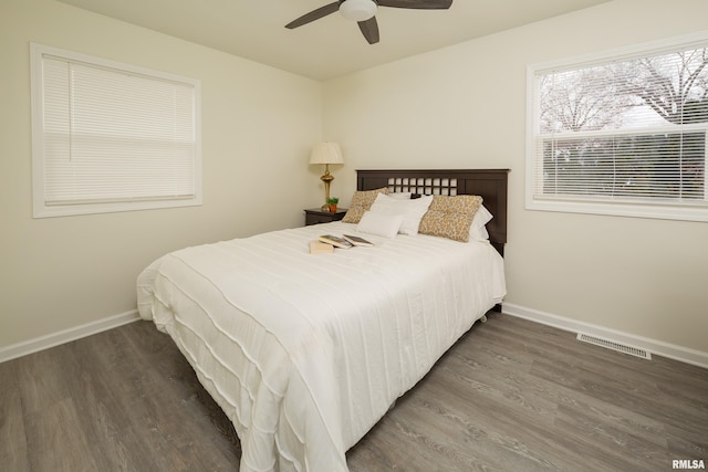 bedroom with ceiling fan and dark hardwood / wood-style flooring