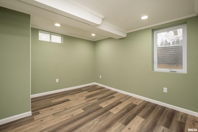 basement with crown molding and hardwood / wood-style flooring