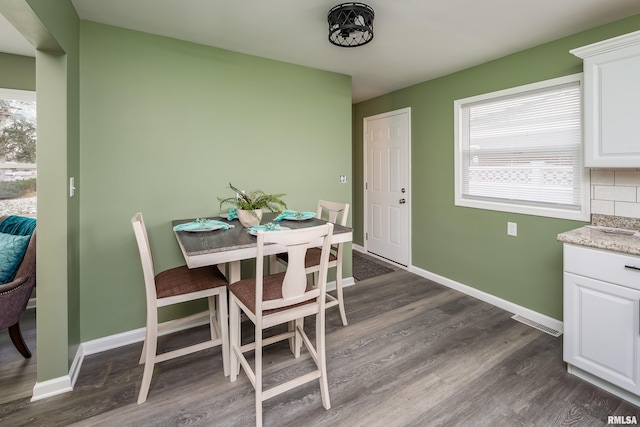 dining area featuring dark wood-type flooring