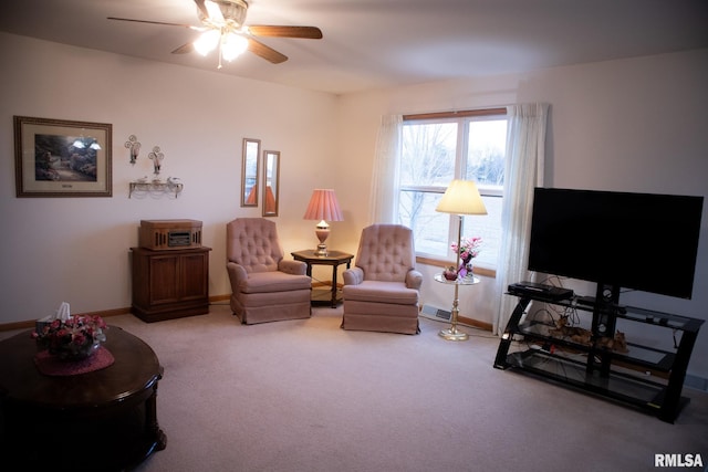 carpeted living area featuring ceiling fan, visible vents, and baseboards