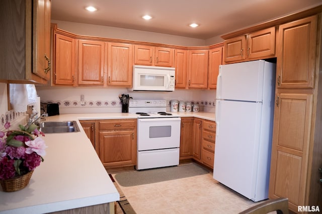 kitchen with light countertops, white appliances, a sink, and recessed lighting