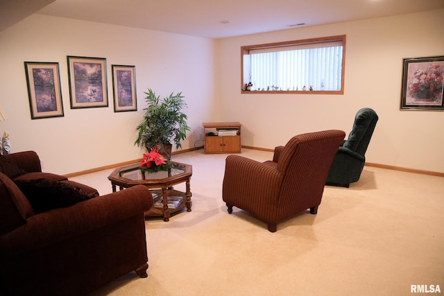 living area featuring carpet flooring, visible vents, and baseboards