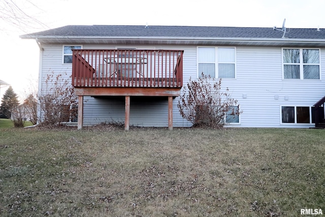 back of property with roof with shingles, a yard, and a wooden deck