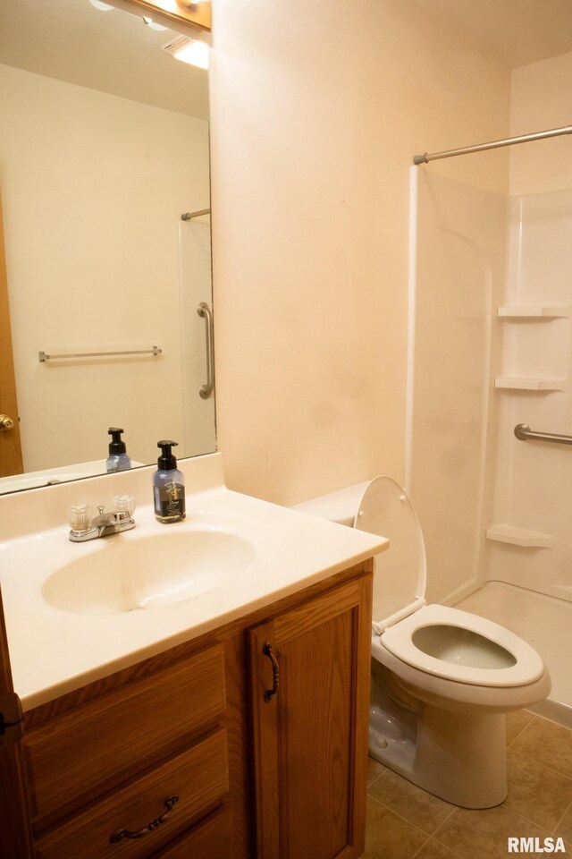 full bath with a shower, vanity, toilet, and tile patterned floors