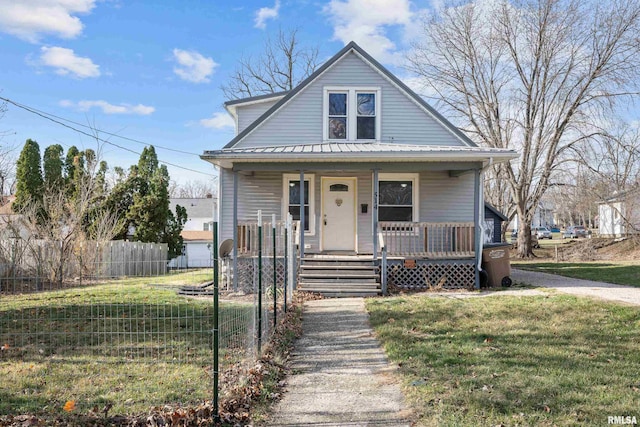 bungalow-style home with a front lawn and covered porch