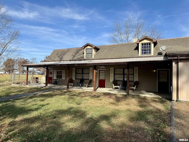 view of front of property with a patio area and a front lawn