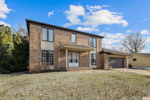 view of front of house with a garage and a front lawn