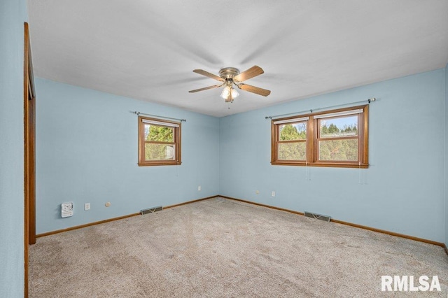 carpeted empty room featuring ceiling fan