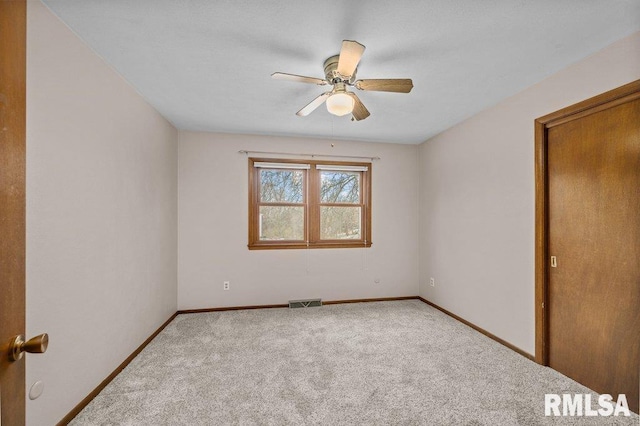 spare room with carpet flooring and ceiling fan