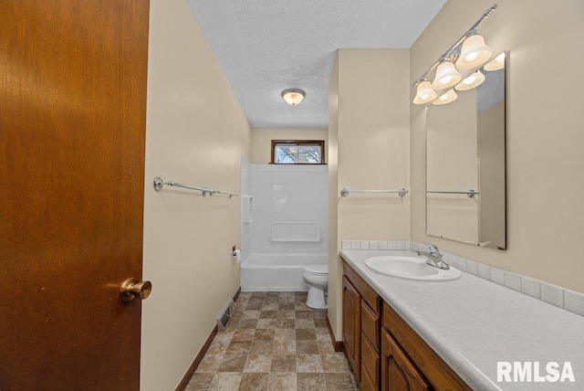 bathroom featuring vanity, a textured ceiling, and toilet