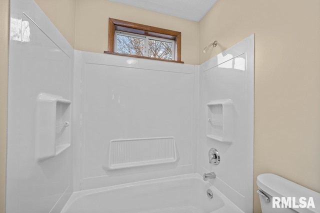 bathroom featuring toilet and shower / bathtub combination