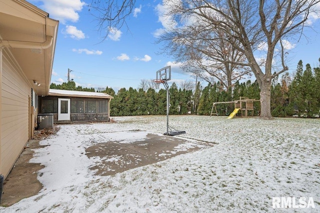 view of yard featuring a playground, a patio area, and a sunroom