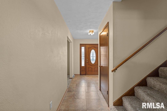 doorway featuring light tile patterned flooring