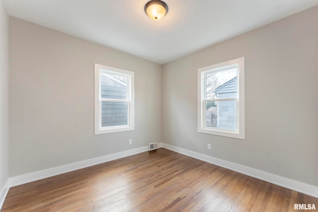 empty room featuring hardwood / wood-style floors and a healthy amount of sunlight