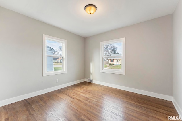 unfurnished room with wood-type flooring