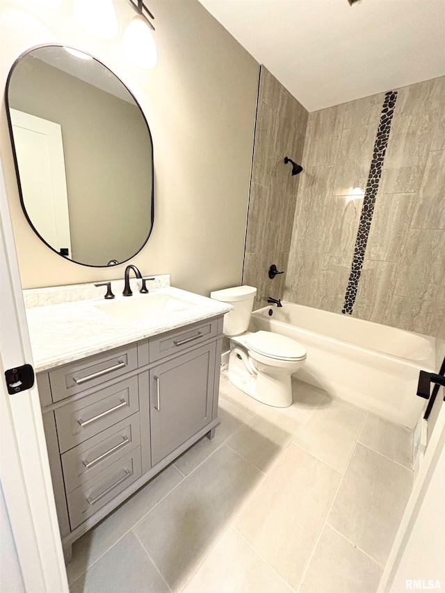 full bathroom featuring toilet, tile patterned flooring, vanity, and tiled shower / bath