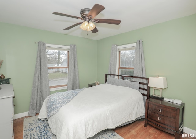 bedroom with ceiling fan and light wood-type flooring