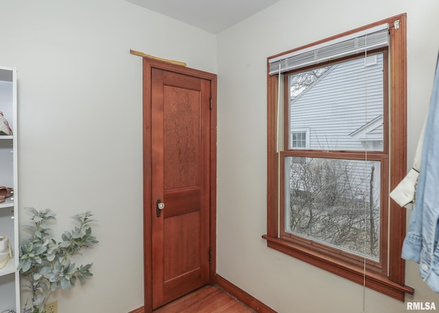 corridor with light hardwood / wood-style floors